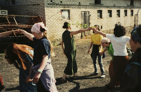 Carol singers dancing in the yard